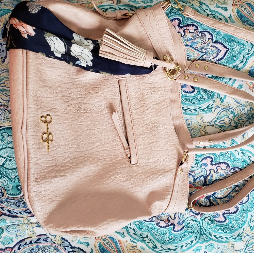 Crossbody bag with tassel and scarf.